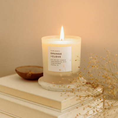 Orange + Clove candle in a white frosted vessel