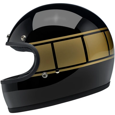 Product image of Biltwell's Holeshot ECE helmet. Black motorcycle helmet with gold squares wrapping around the helmet.