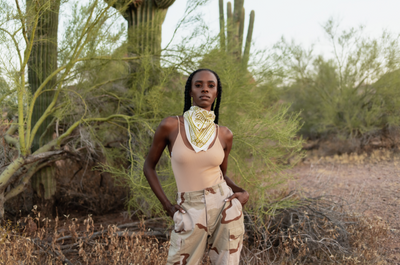 Person wearing the "Come Together" bandana around their neck while standing in a desert with cacti behind them.