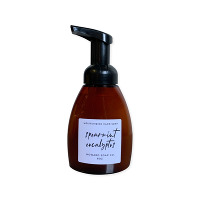 Product image of the Spearmint + Eucalyptus  Foaming Hand Soap. Plastic amber bottle with black pump