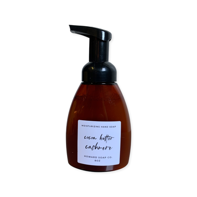 Product image of the Cocoa Butter Cashmere  Foaming Hand Soap. Plastic amber bottle with black pump