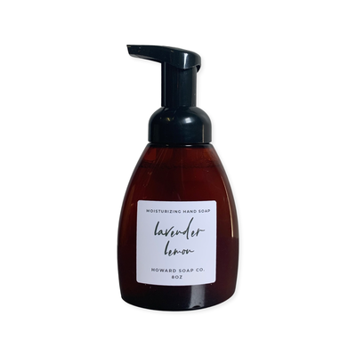 Product image of the Lemon Lavender Foaming Hand Soap. Plastic amber bottle with black pump